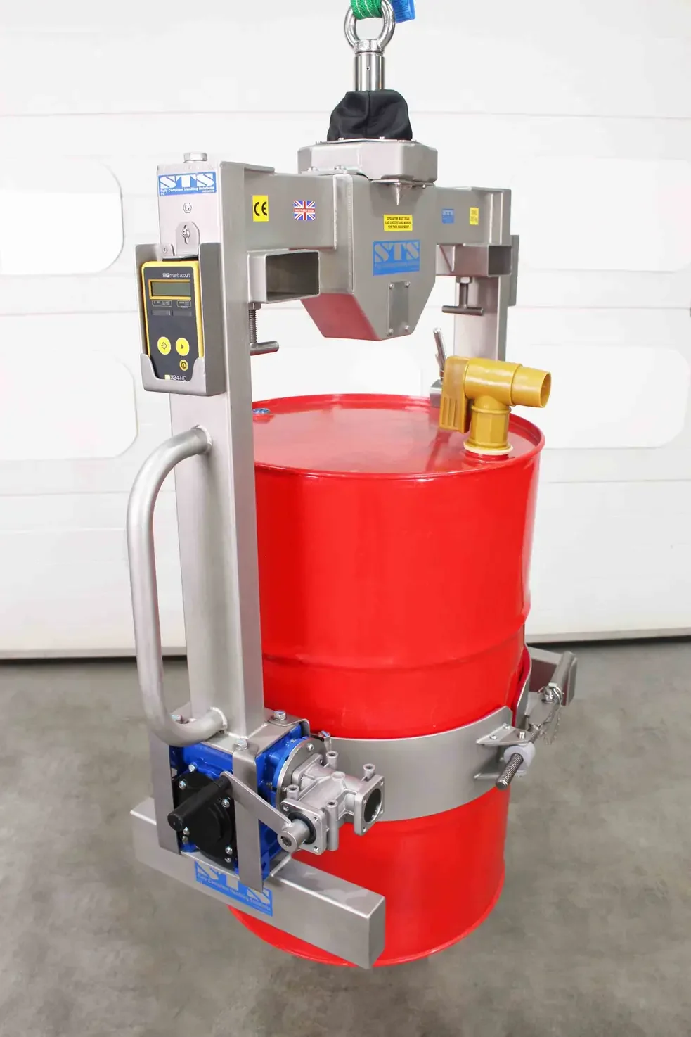 Drum lifter and rotator is holding a 55 gallon drum with details on the wireless and manual controls.