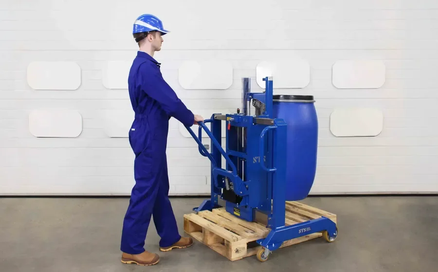 operator using a drum lifter that is straddling a narrow 32" pallet while lifting a plastic barrel