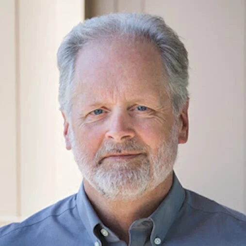 Long-term addictinon and mental health provider Rick Treleaven looks at camera wearing a blue shirt.