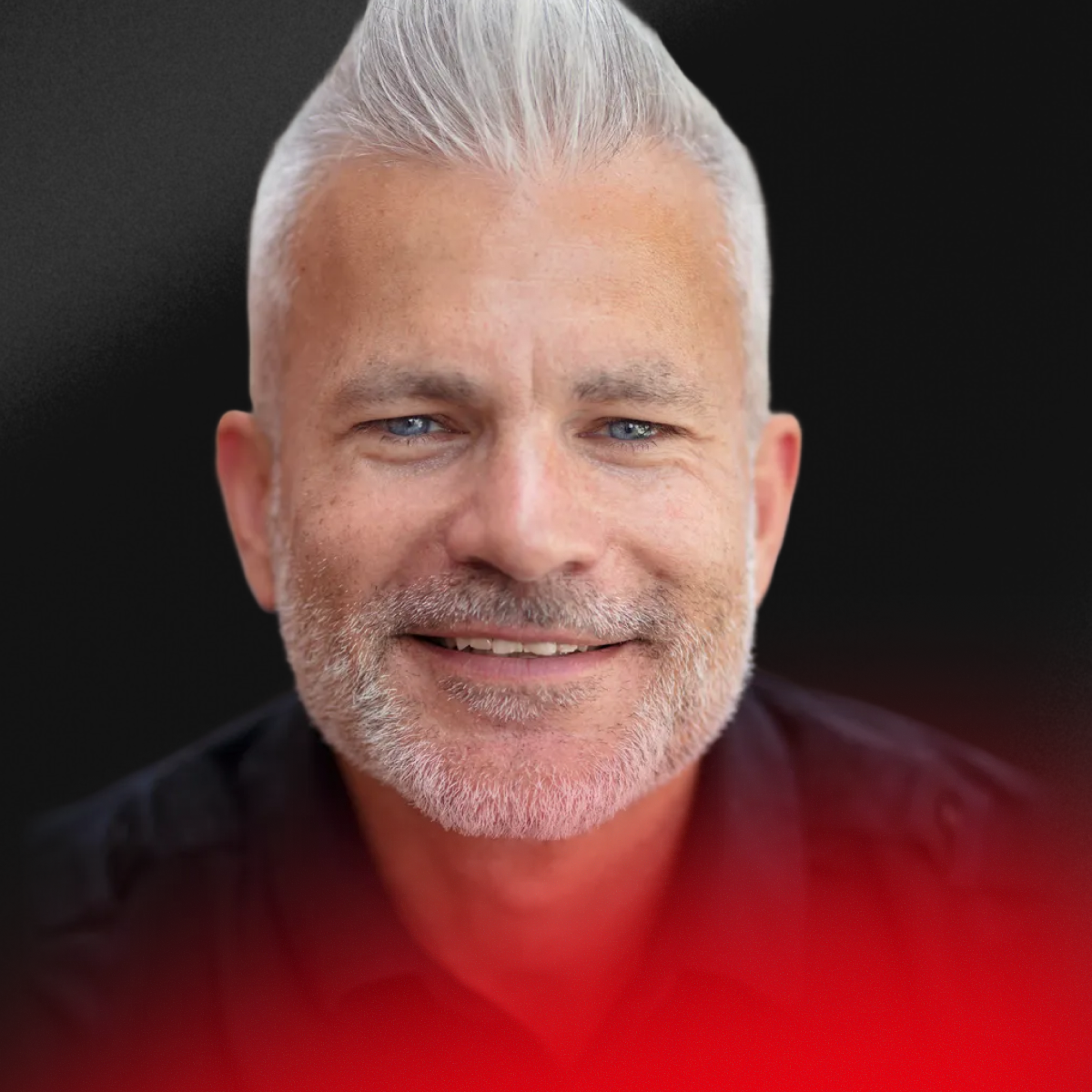 Blurred portrait of a person with short dark hair wearing a black shirt.