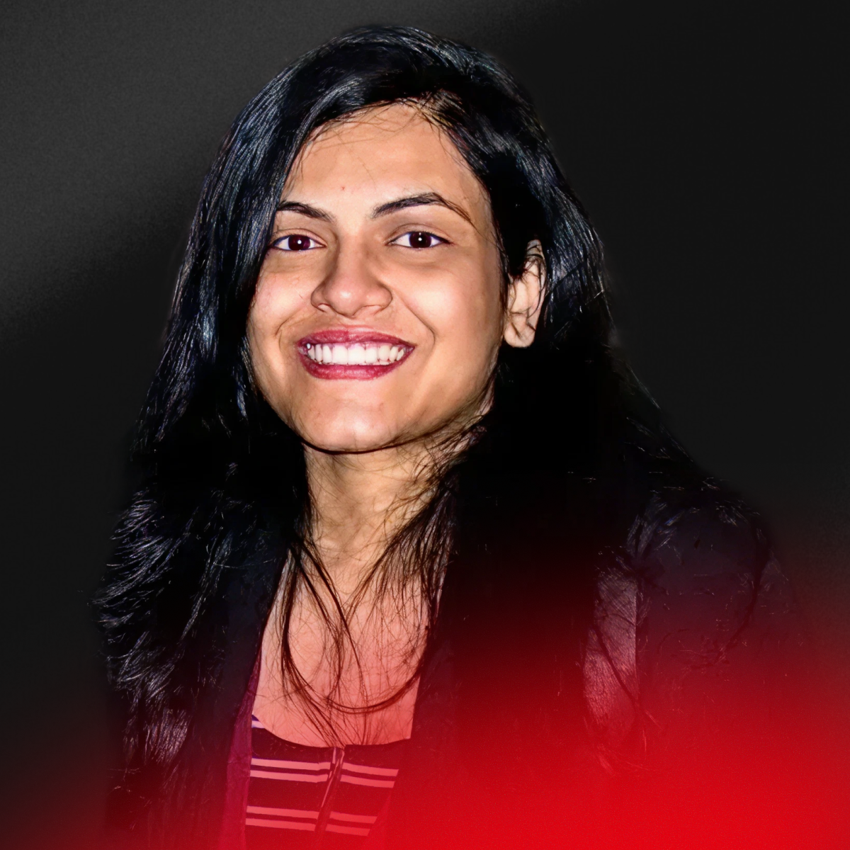 Blurry portrait of a person with short dark hair wearing a black top against a light background.