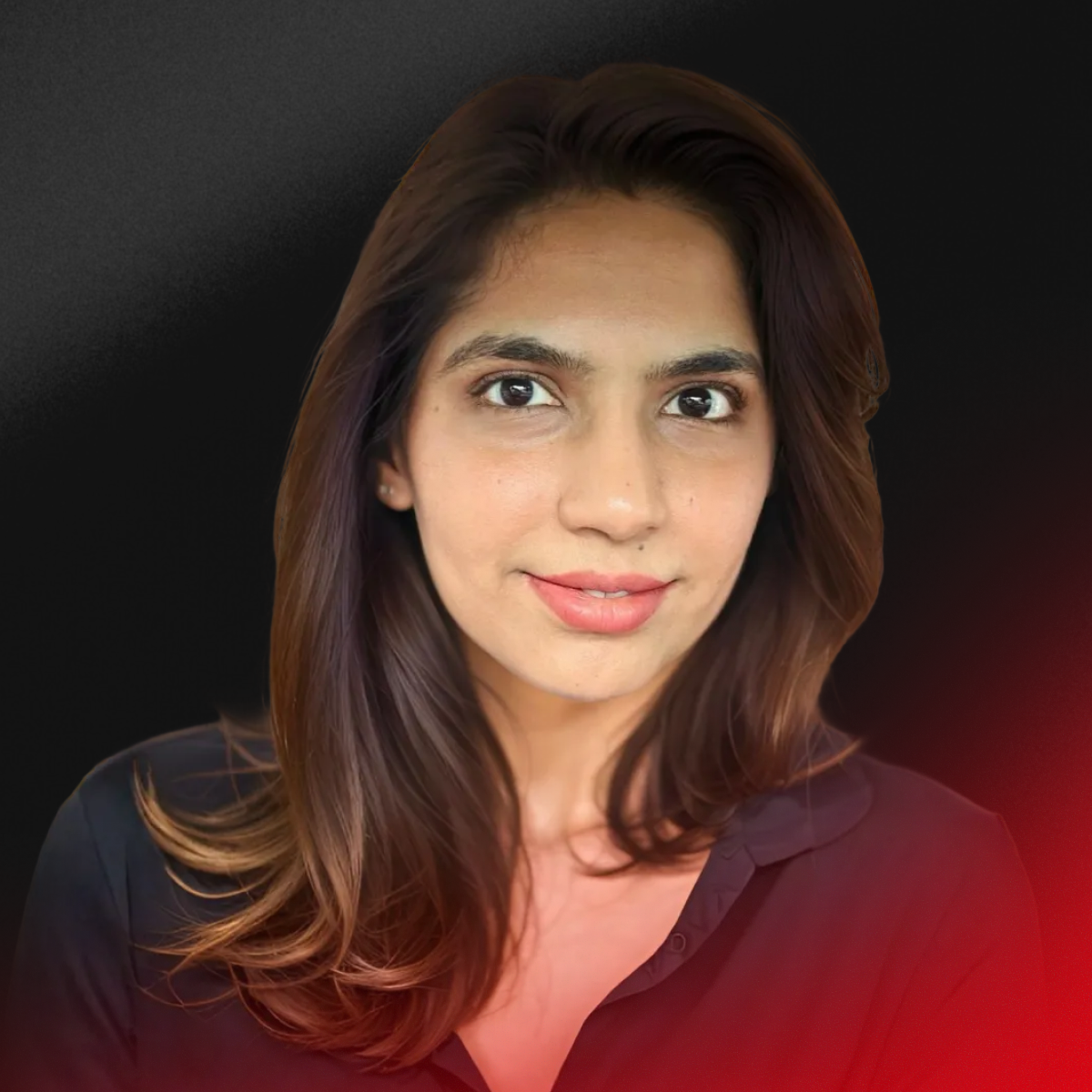 A blurred portrait of a person with short dark hair wearing a black top against a light background.