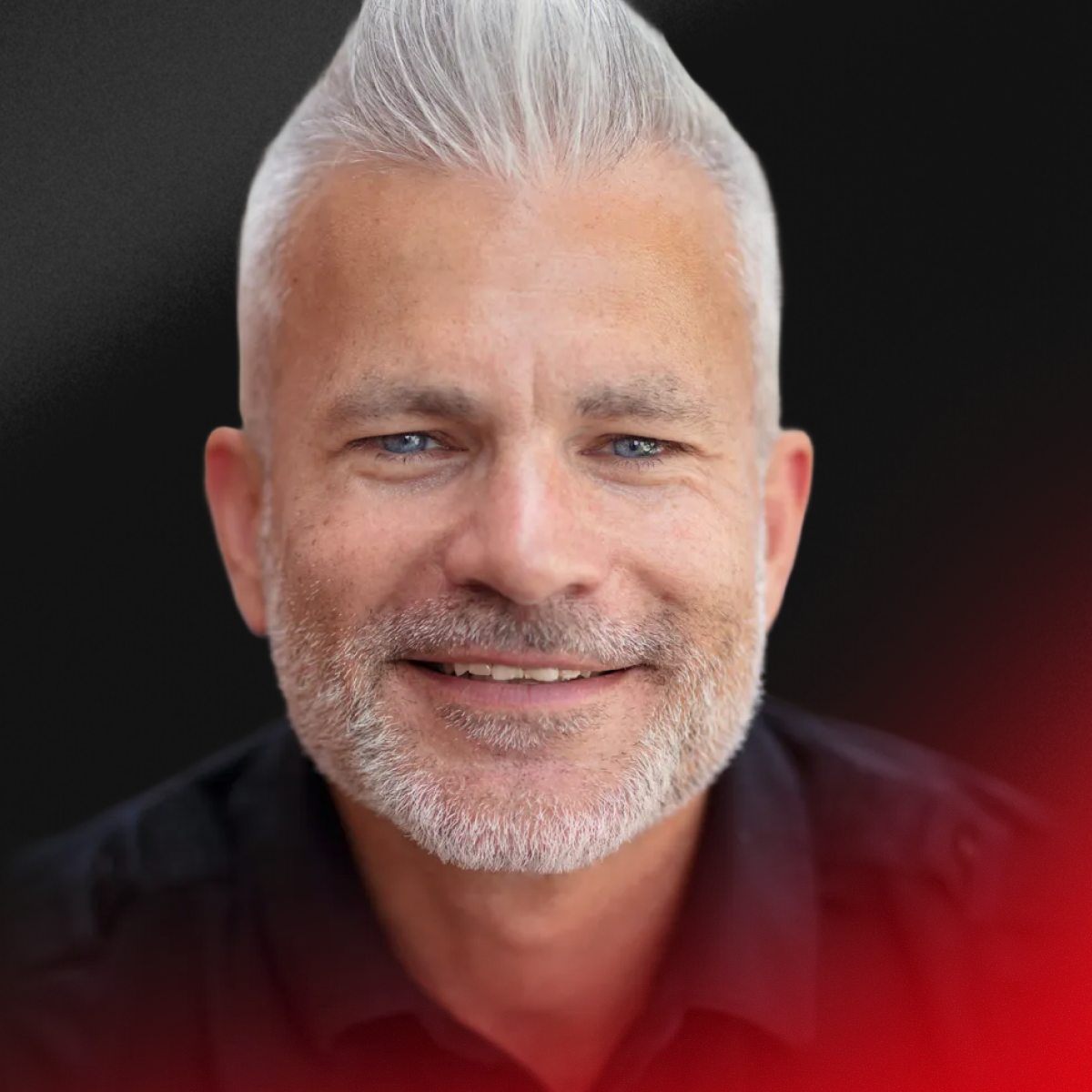 Blurred portrait of a person with short dark hair wearing a black shirt.