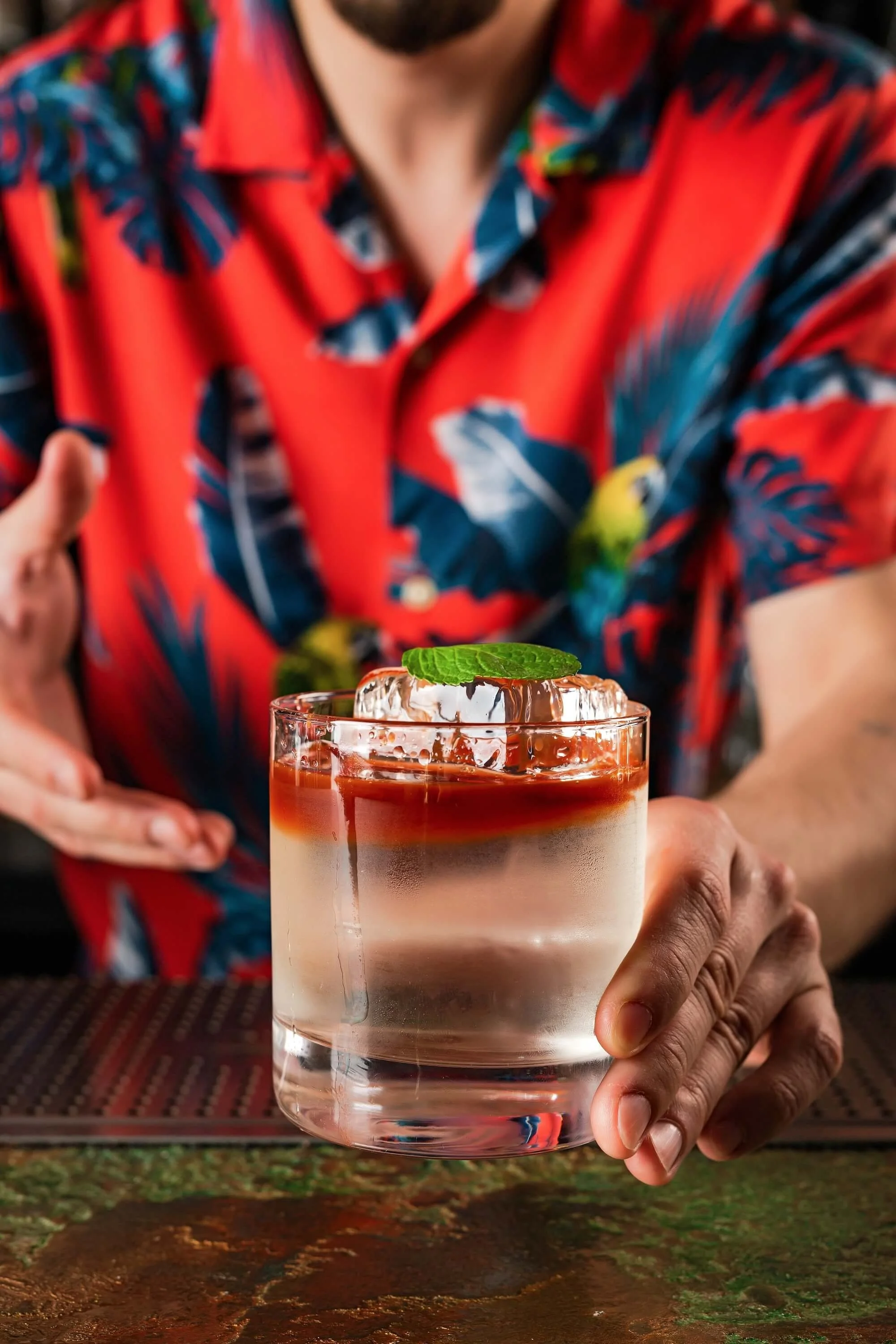 bartender-in-a-hawaiian-red-shirt-serving-a-drink-2026-01-07-00-24-58-utc (1).jpg