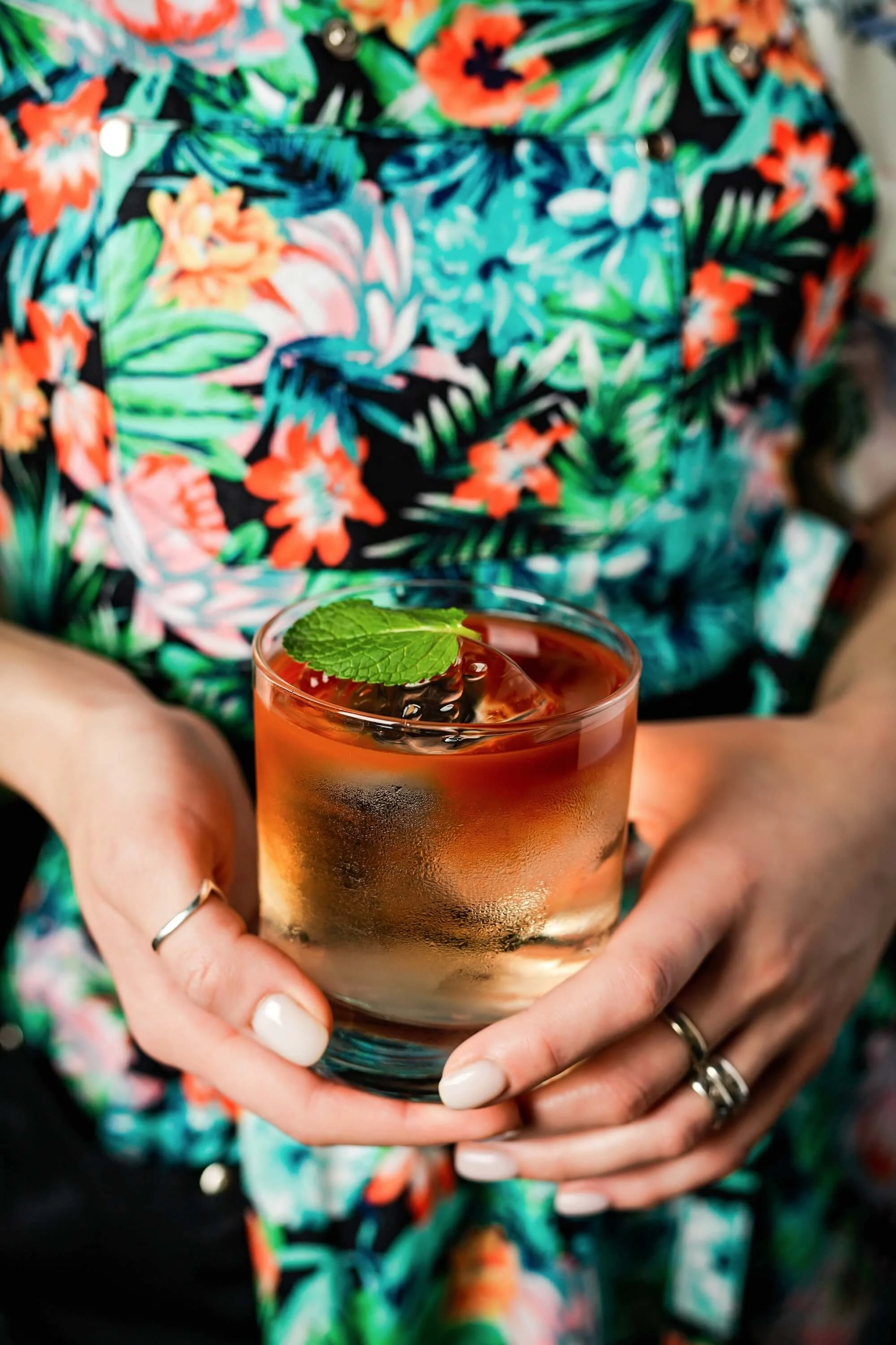 woman-holding-a-tiki-style-layered-cocktail-in-a-r-2026-01-06-10-10-25-utc (1).jpg