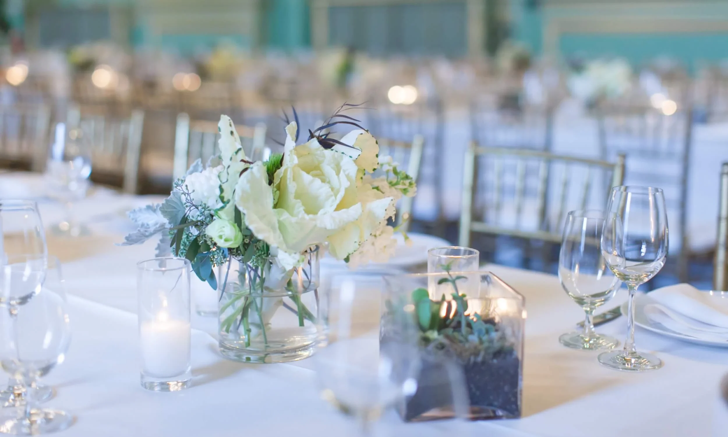 banquet table with floral centerpiece and candlelight