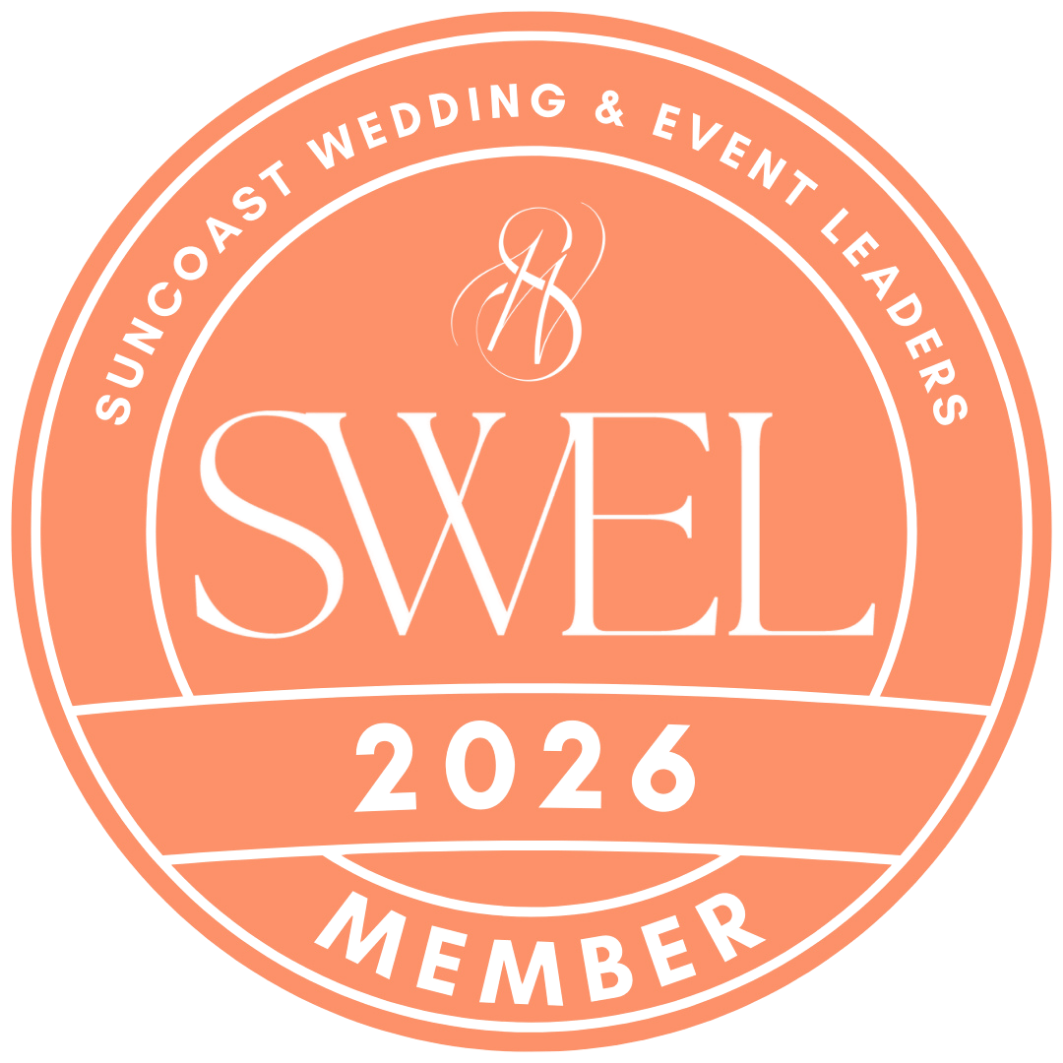 Circular badge with light orange background and white text that reads "SWEL 2026 Member". The outer ring says "Suncoast Wedding & Event Leaders". The badge includes a stylized monogram "SW" at the top center.