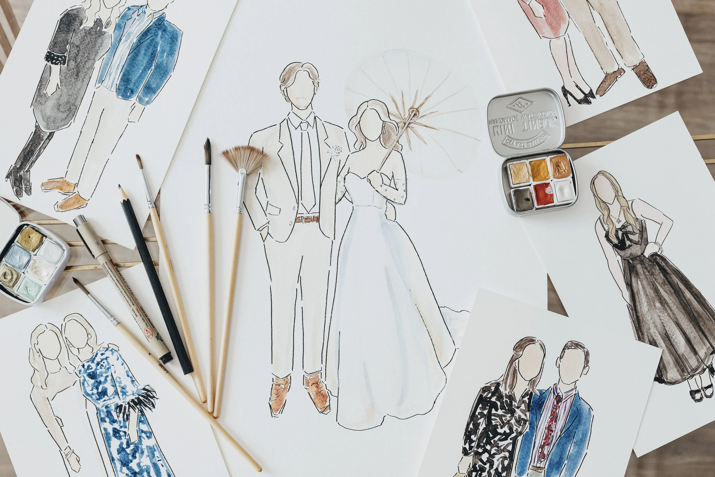 Sketches of people in formal and casual outfits with watercolor paints and brushes on white paper.