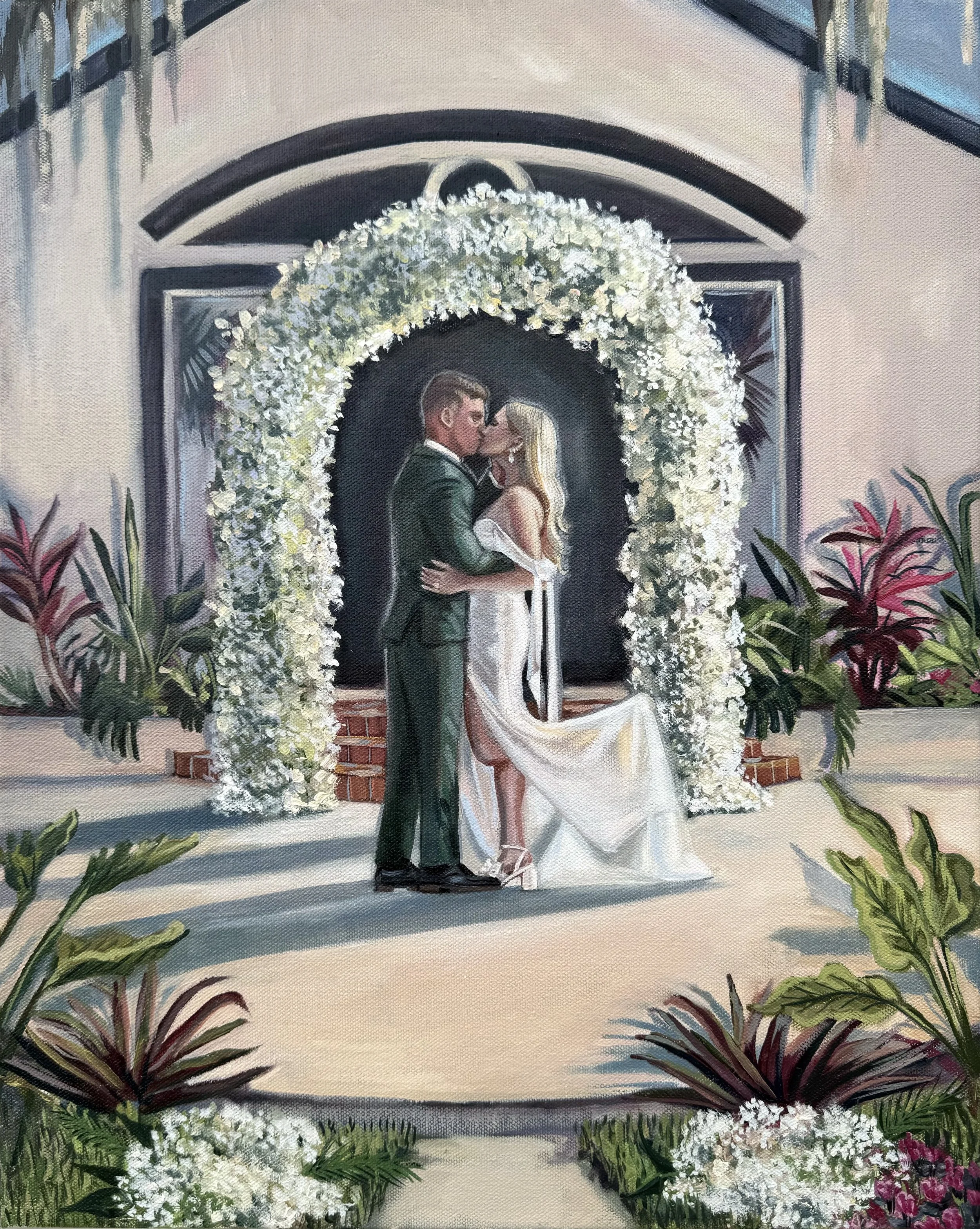 A painting of a couple sharing a kiss during their wedding, standing under a large white floral arch in front of a building with an arched entrance. The bride wears a white wedding dress and the groom is in a dark suit. The setting is decorated with 