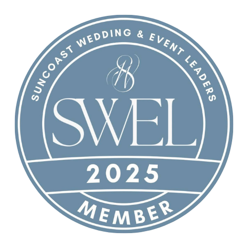 Circular badge with light blue background and white text that reads "SWE L 2025 Member". The outer ring says "Suncoast Wedding & Event Leaders". The badge includes a stylized monogram "SH" at the top center.