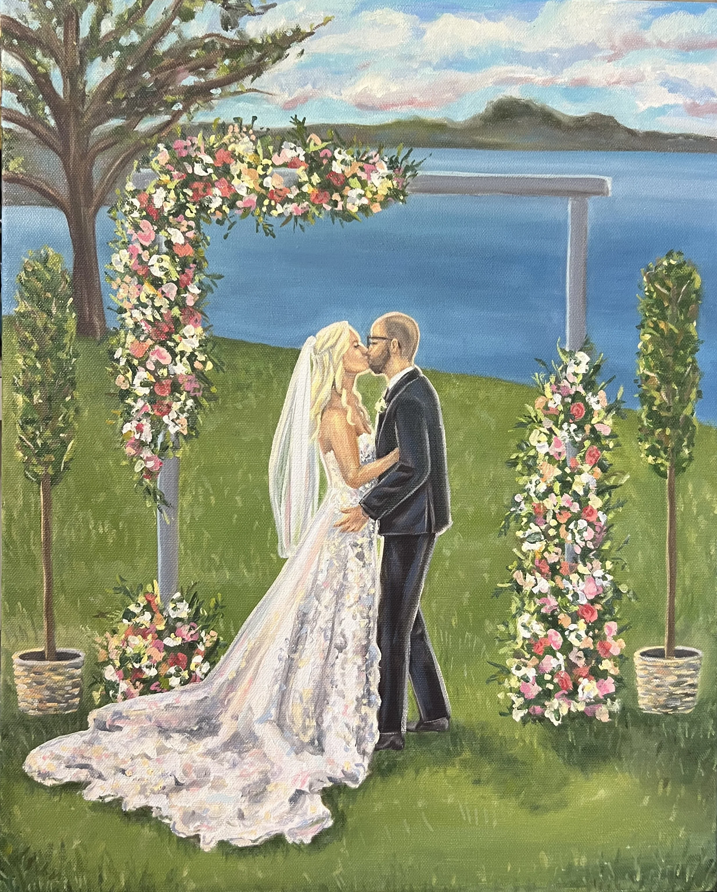 A painting of a bride and groom sharing a kiss during their outdoor wedding ceremony near a body of water, with a floral arch and greenery.