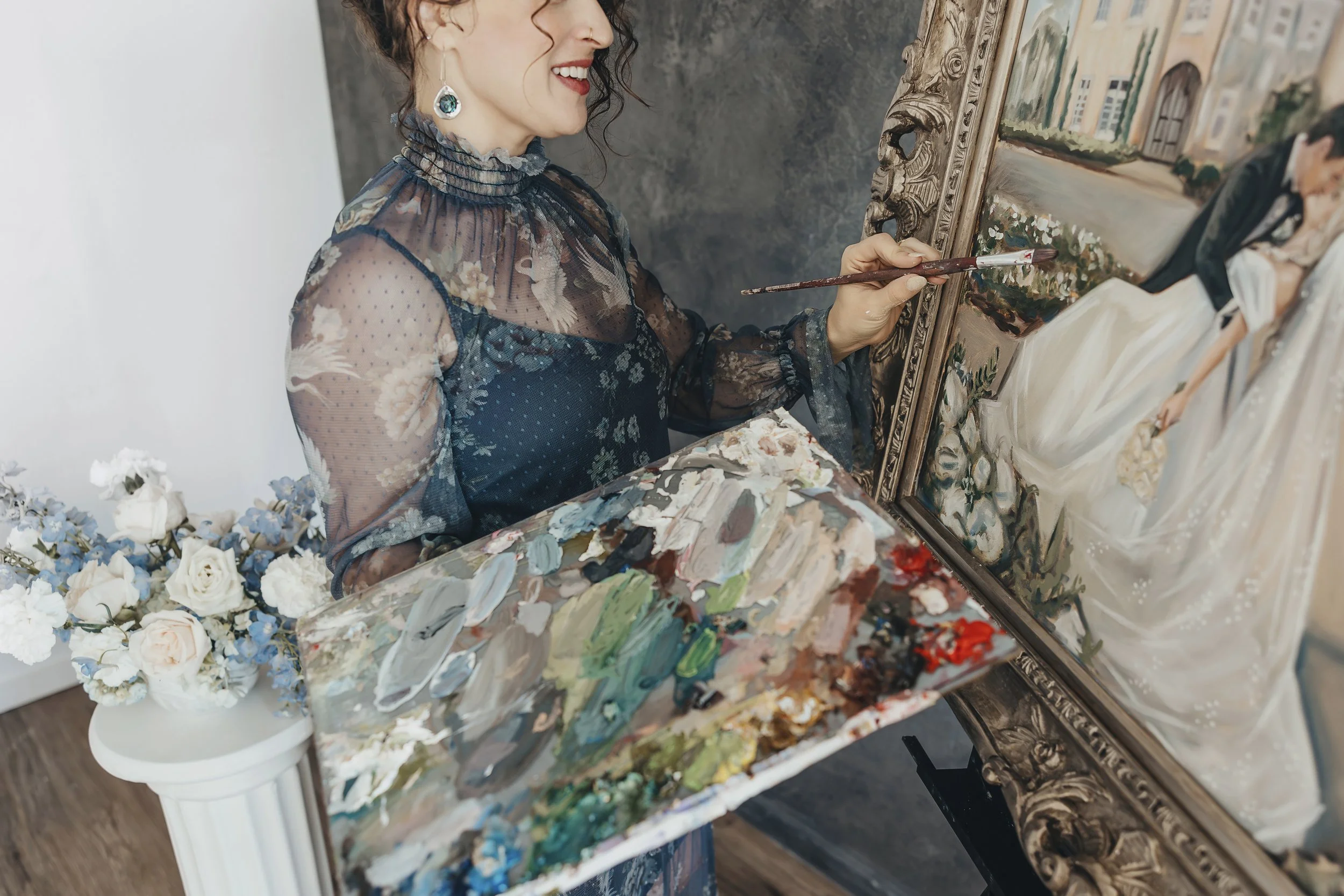 Holly painting a framed portrait of a woman in an elegant white gown holding a bouquet, in an art gallery setting.