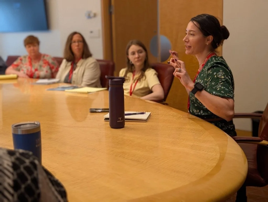 Jessica Berg teaching writers around a conference table