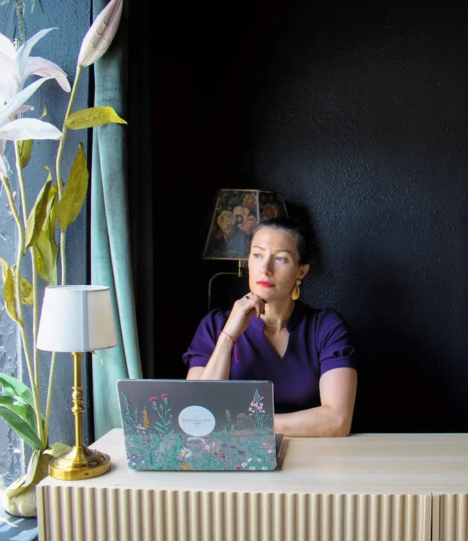 Jessica Berg at her desk with a laptop, reading pages