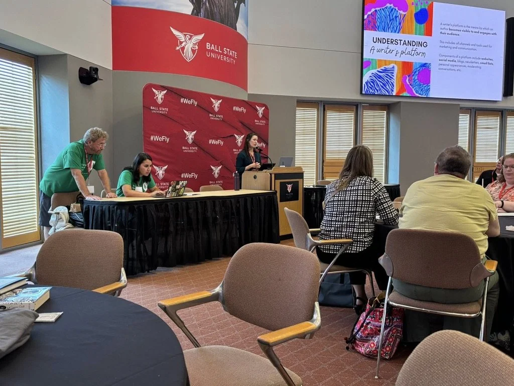 Jessica Berg presenting at a podium on building a writer’s platform
