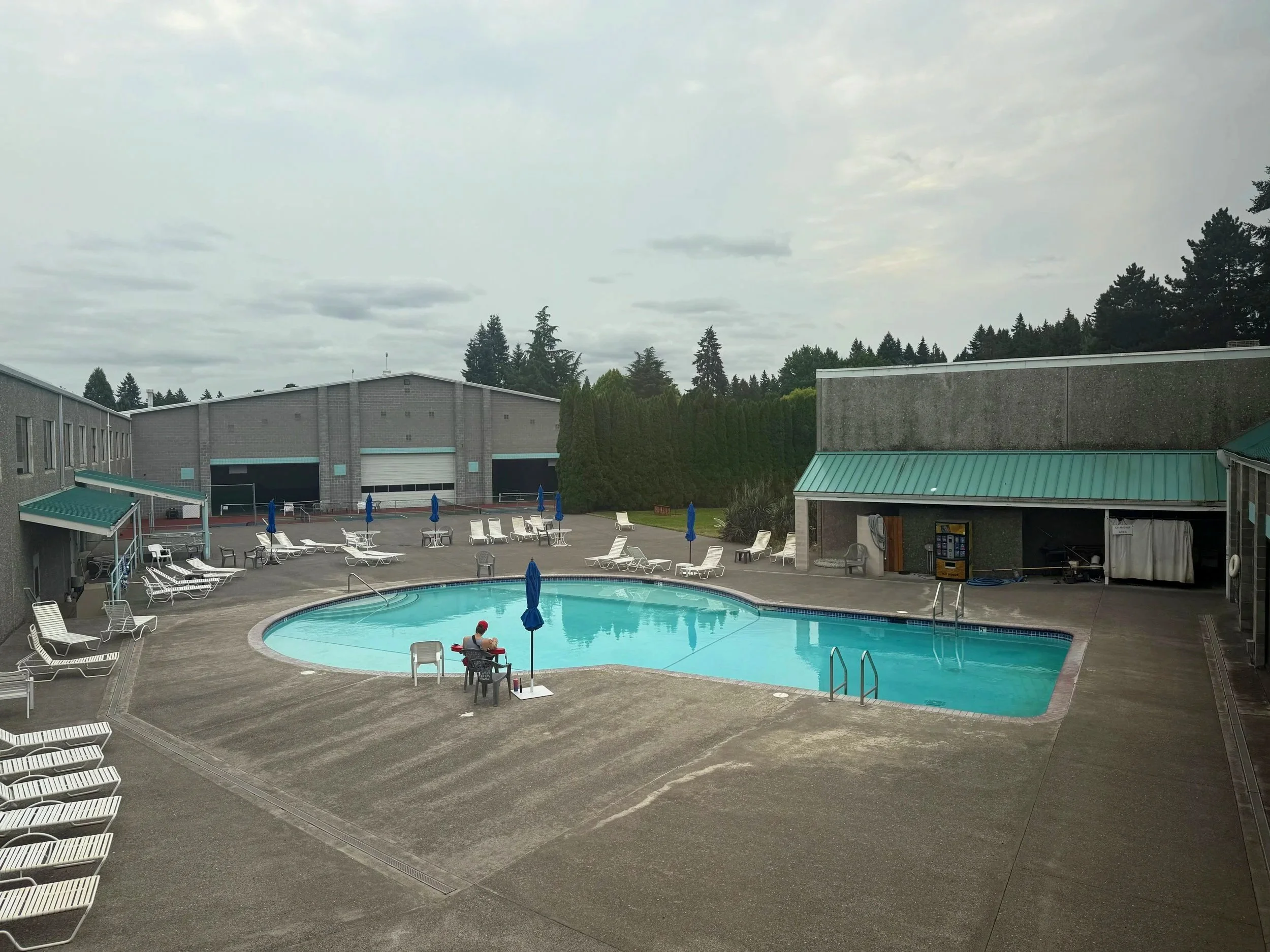 Outdoor swimming pool with lounge chairs, umbrellas