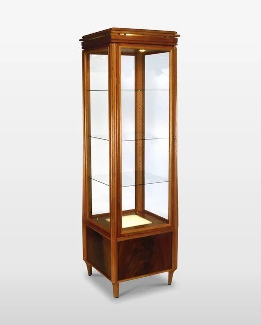 Wooden display cabinet with glass shelves and glass doors, standing on four legs.