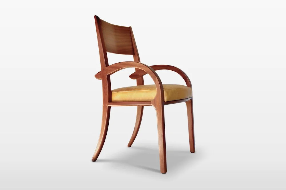 Wooden chair with armrests and yellow cushioned seat against a plain white background.