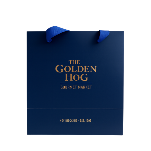 Bolsa azul con asas y texto en dorado que dice: "The Golden Hog Gourmet Market, Key Biscayne - Est. 1995".