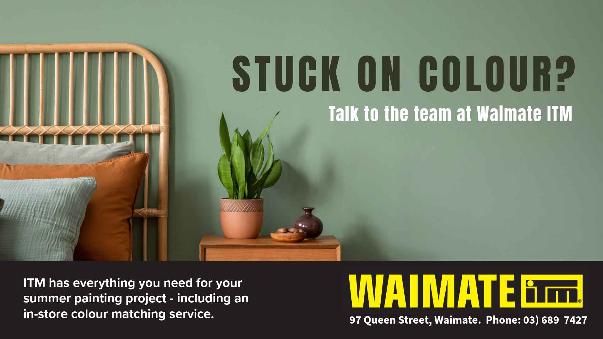 An advertisement for Waimate ITM, featuring a bedroom with a wicker headboard, two pillows, and a small wooden nightstand with a potted plant and decorative items. The text promotes color matching for summer painting projects and invites viewers to talk to the team at Waimate ITM.