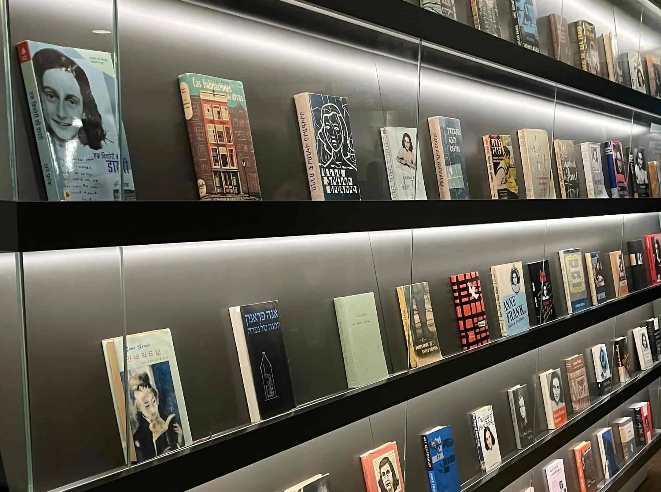 A wall of translated copies of the Diary of Anne Frank at the Anne Frank House in Amsterdam.