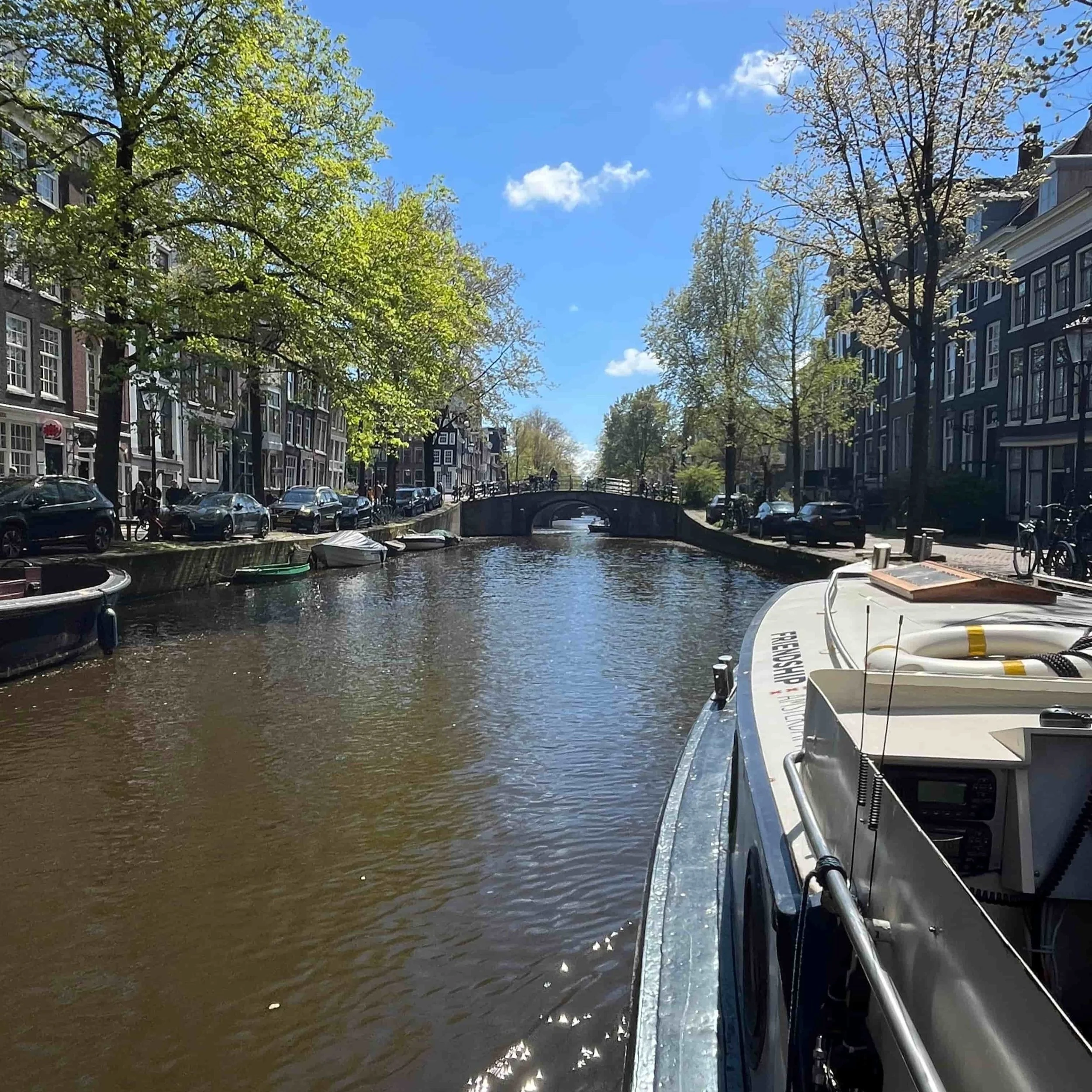 A boat cruising down an Amsterdam canal.