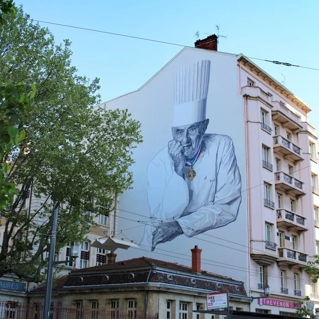 A mural of famed chef Paul Bocuse on the side of a building in Lyon, France.