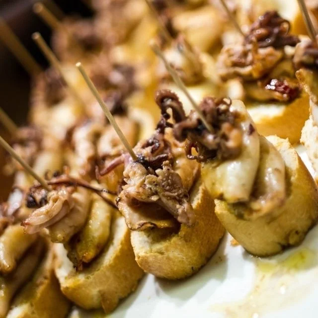 A platter of octopus topped crostini, or pinxtos, in San Sebastian.