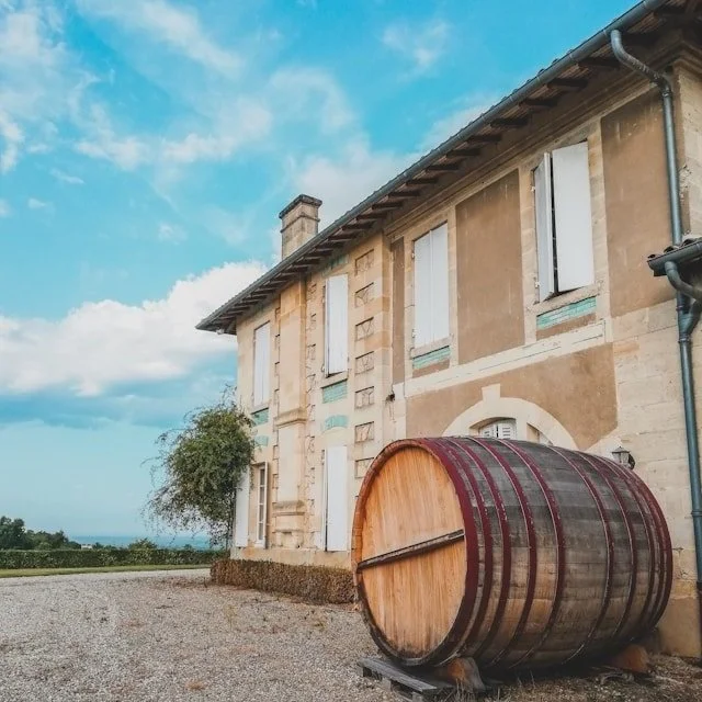 A large oak barrel on a wine estate in Bordeaux, France.