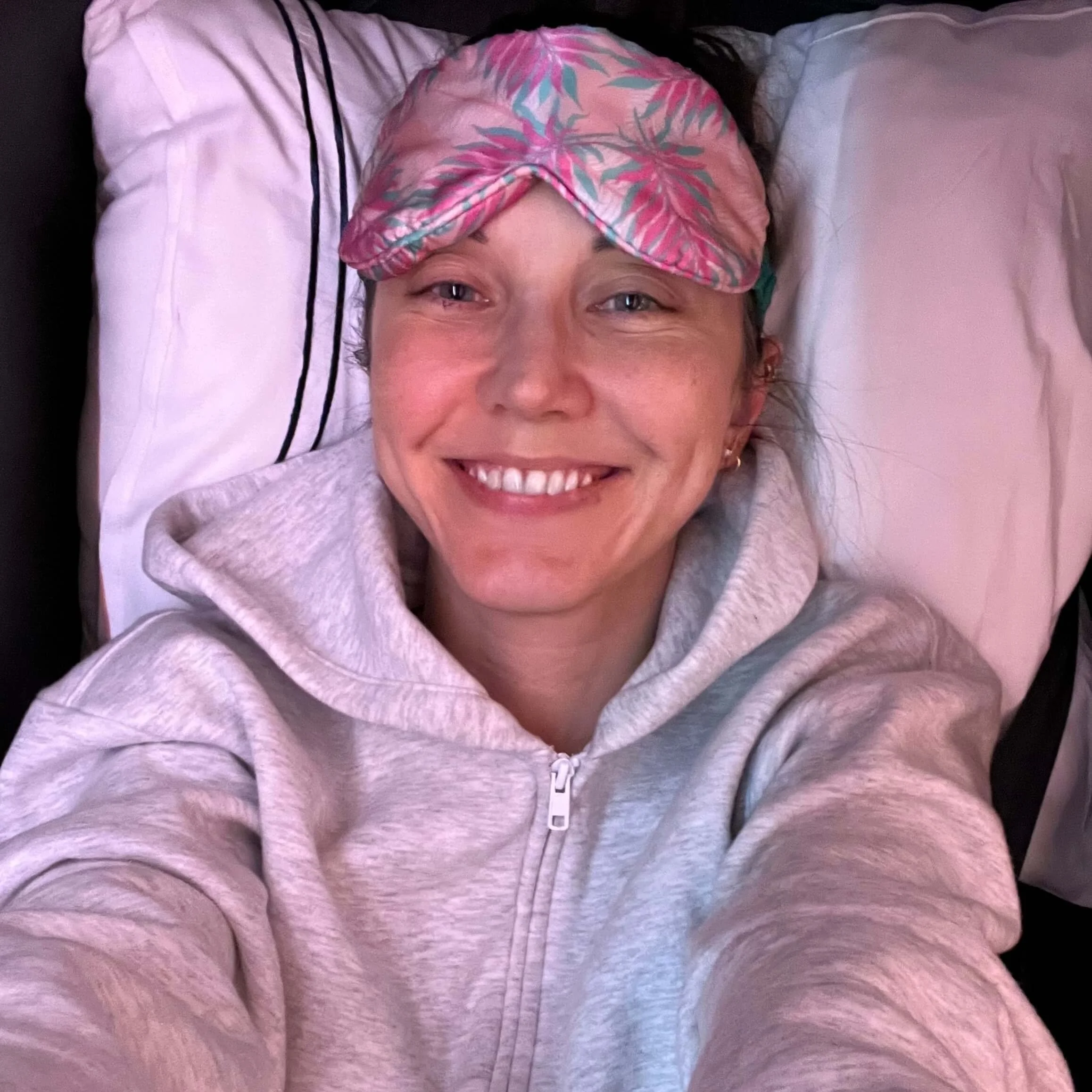 A selfie of the author wearing an eye mask in Delta One first class.