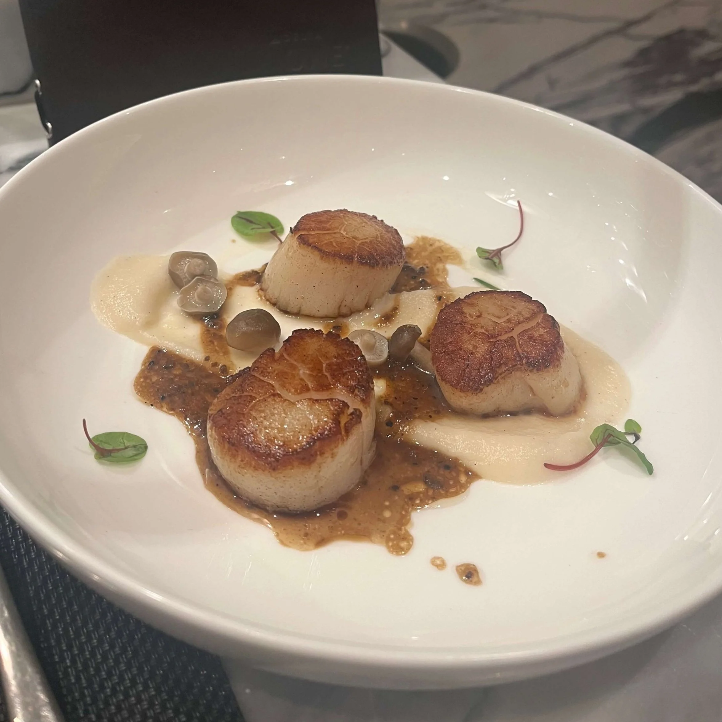Seared scallops served at the Delta One Lounge at JFK Airport.