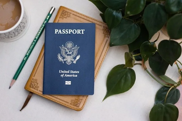 A United States passport sits on a journal.