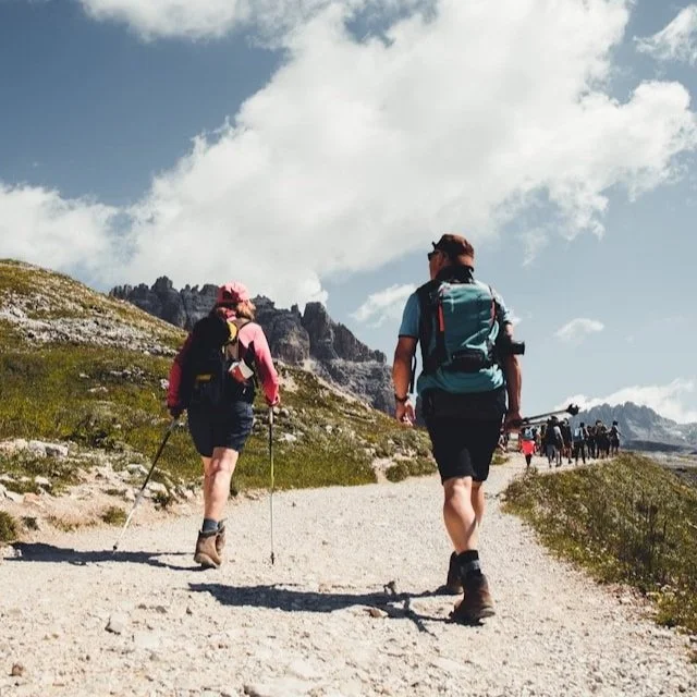 A couple hikes in Canazei, Italy while dressed in breathable shorts and tops.