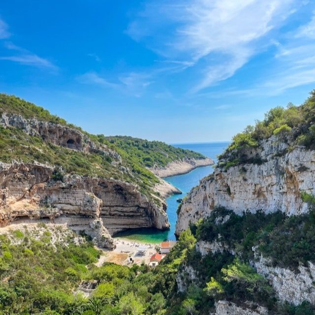 Stiniva Beach, nestled between towering cliffs in Vis, Croatia.