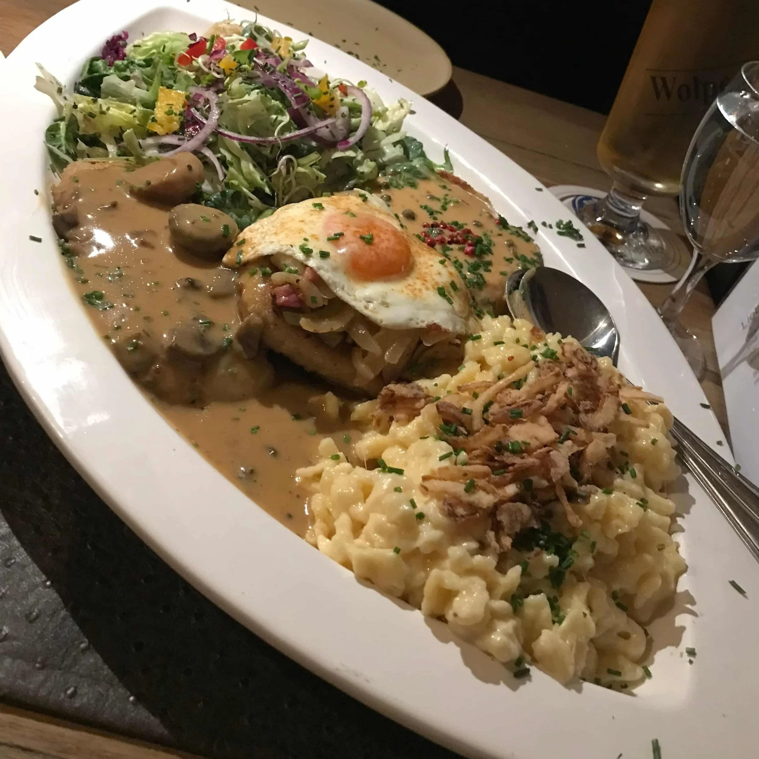 A platter of pork steaks and spätzle at Wirtshaus Wolpertinger, a restaurant in Garmisch-Partenkirchen.