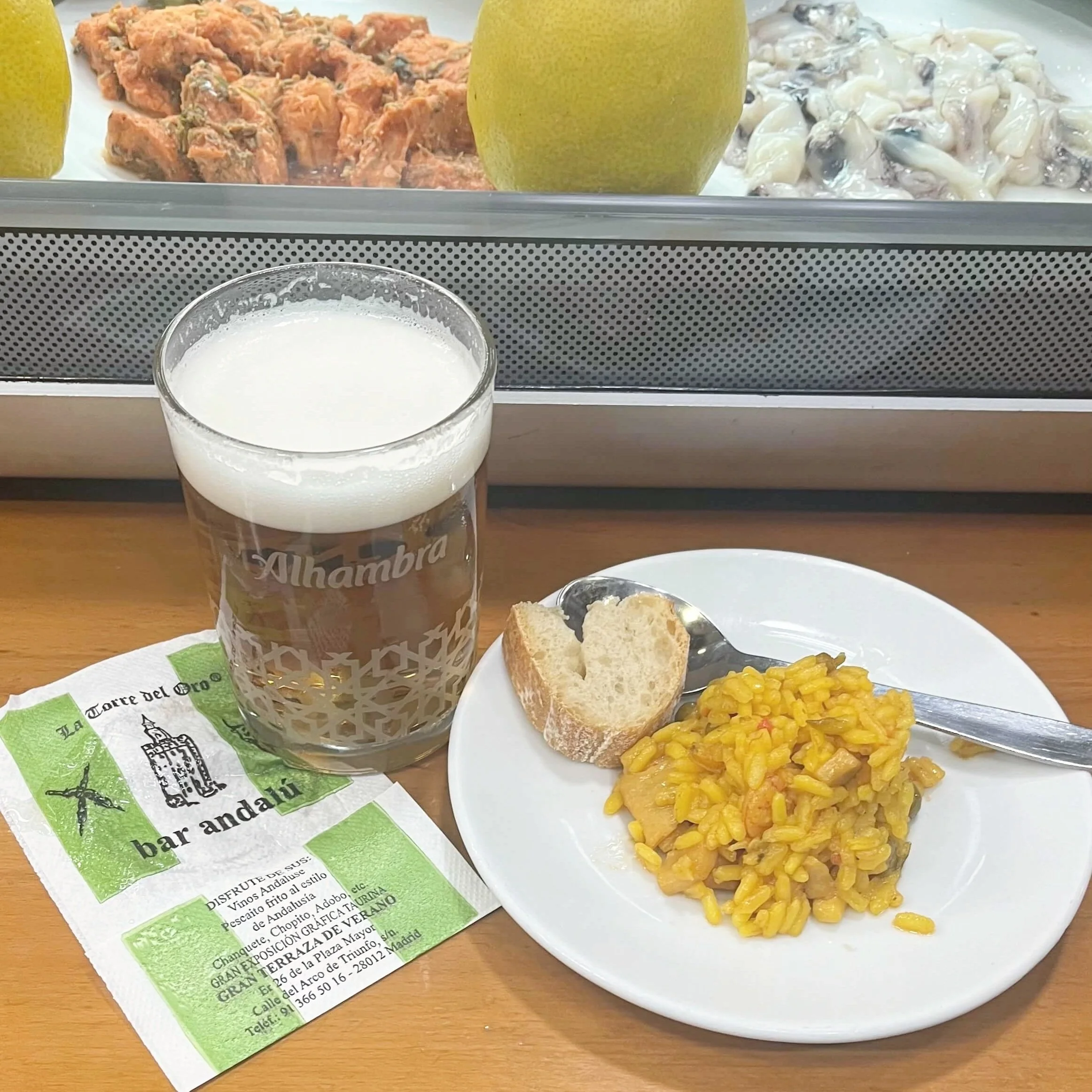 Tapas of paella along with a cold beer.