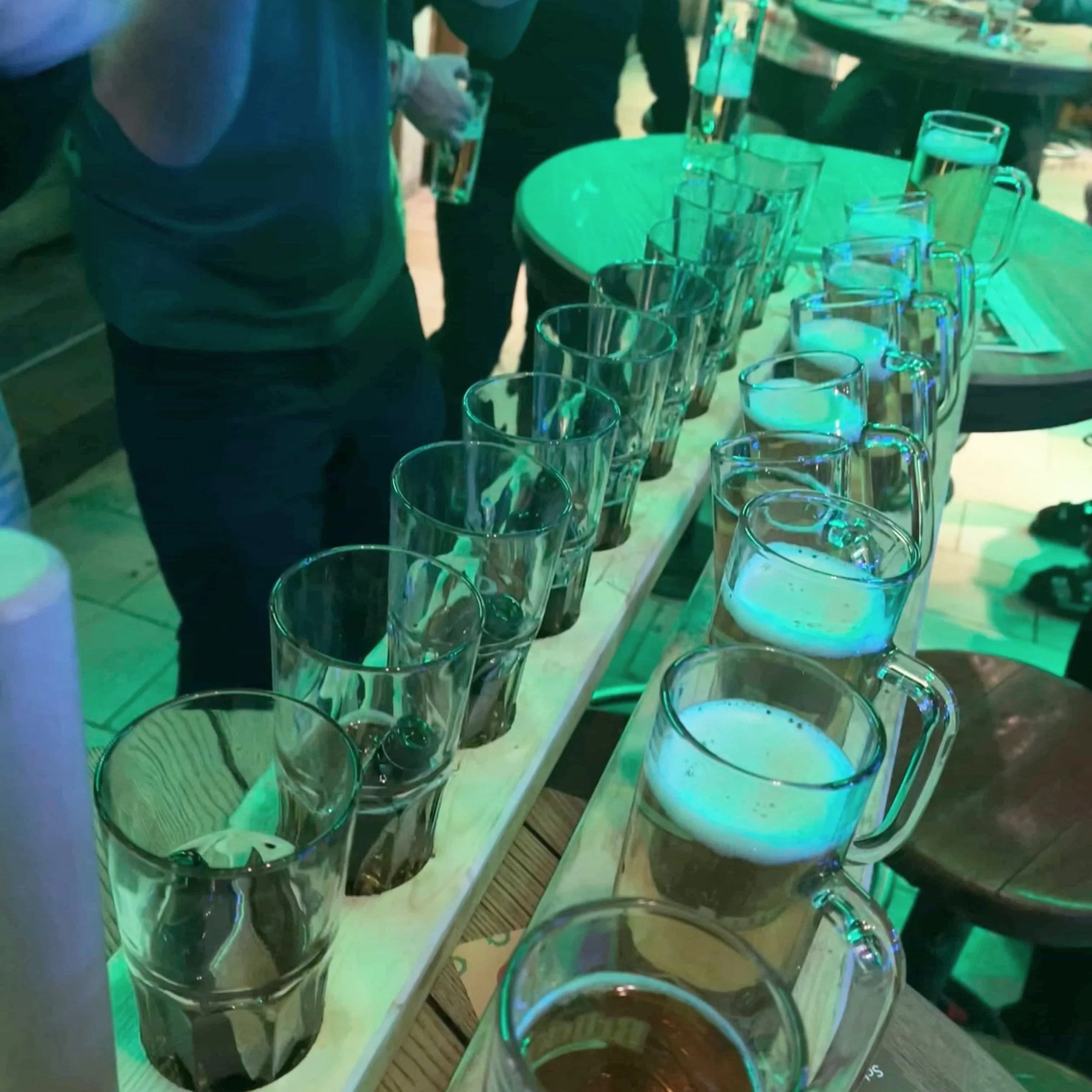 A row of beers and Jägermeister served on a wood plank at the Brück’n Stadl in Mayrhofen, Austria.