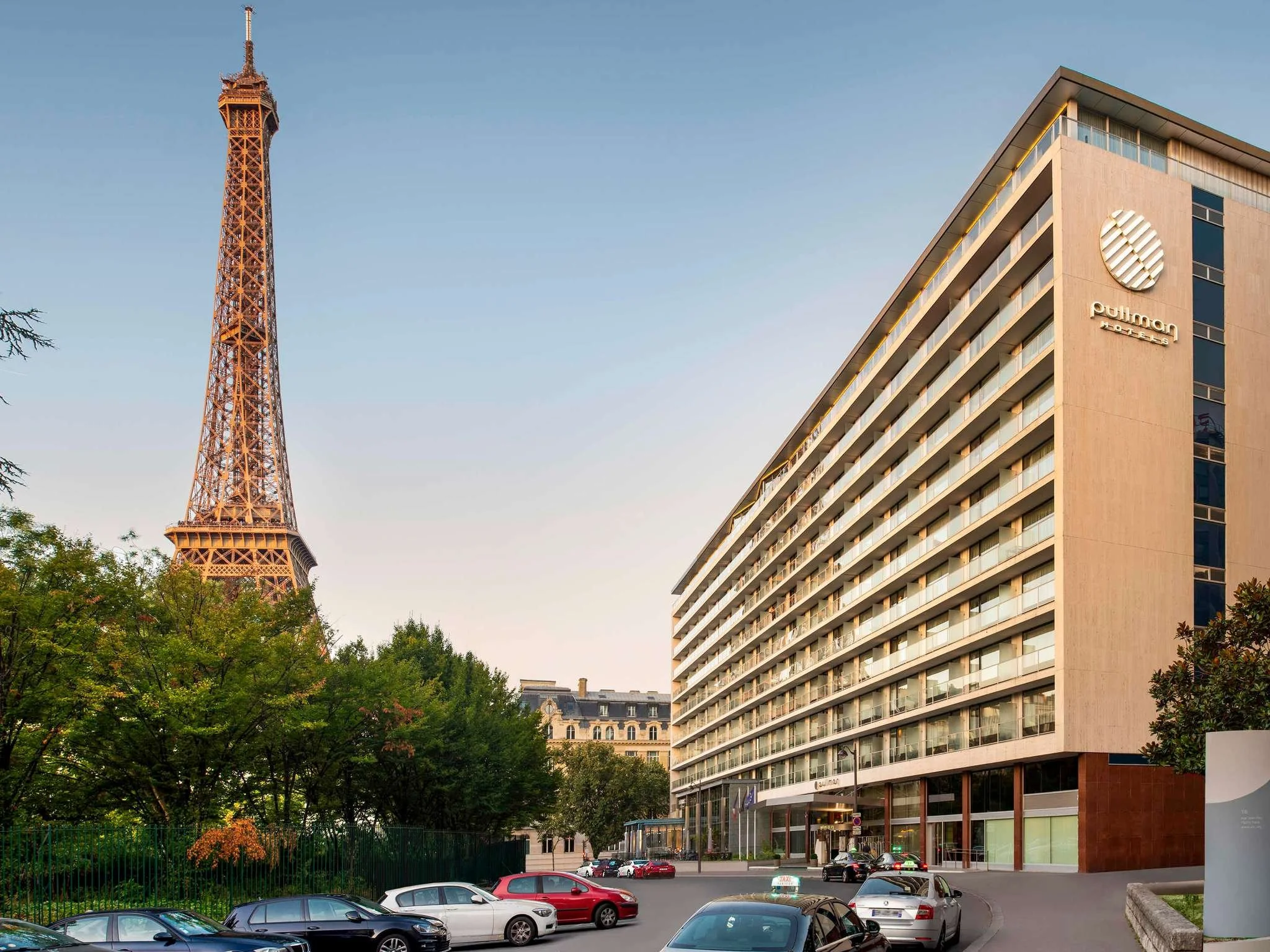 The exterior of the Pullman Paris Tour Eiffel next to the Eiffel Tower in Paris, France.