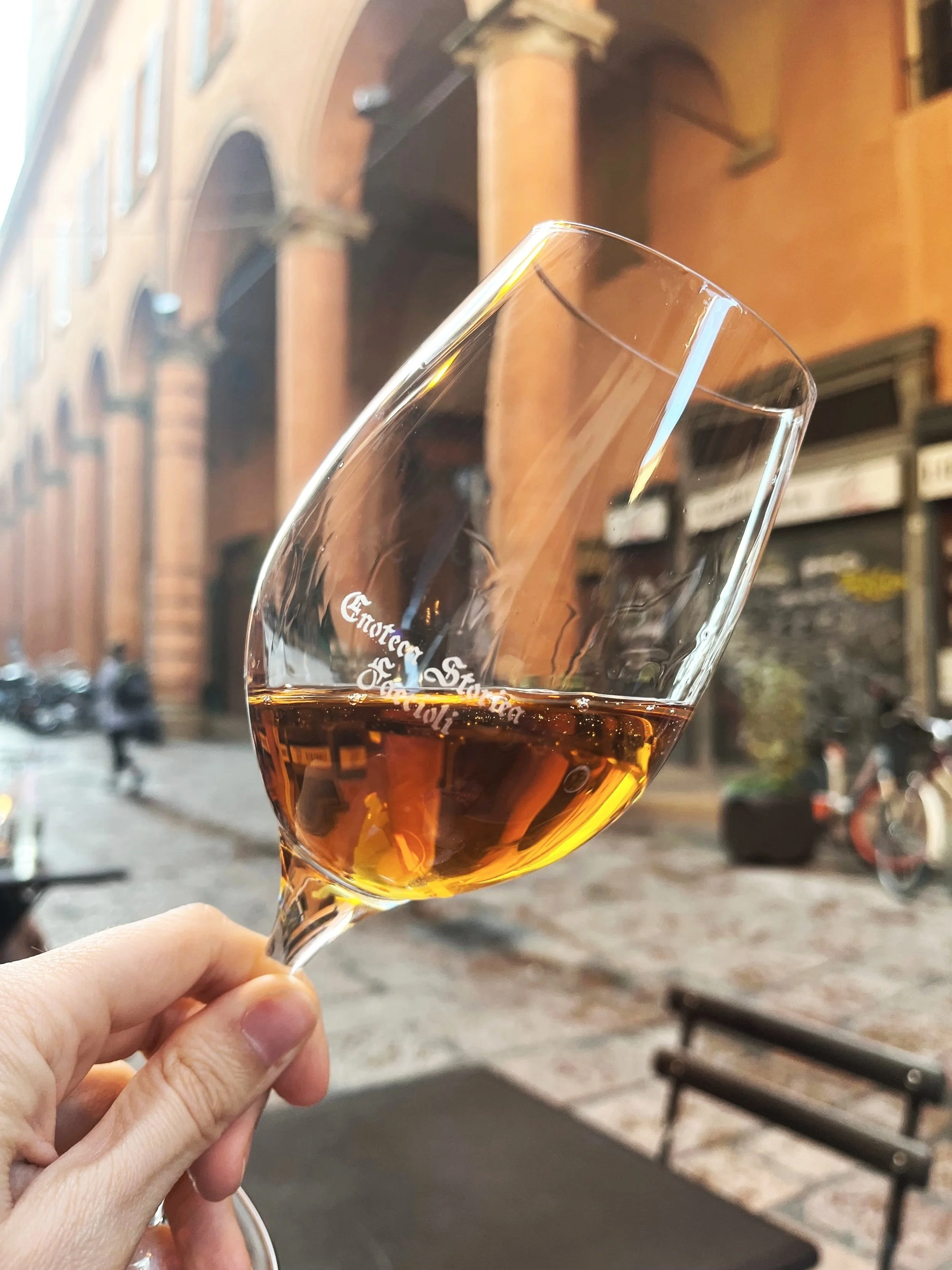 A glass of natural orange wine.