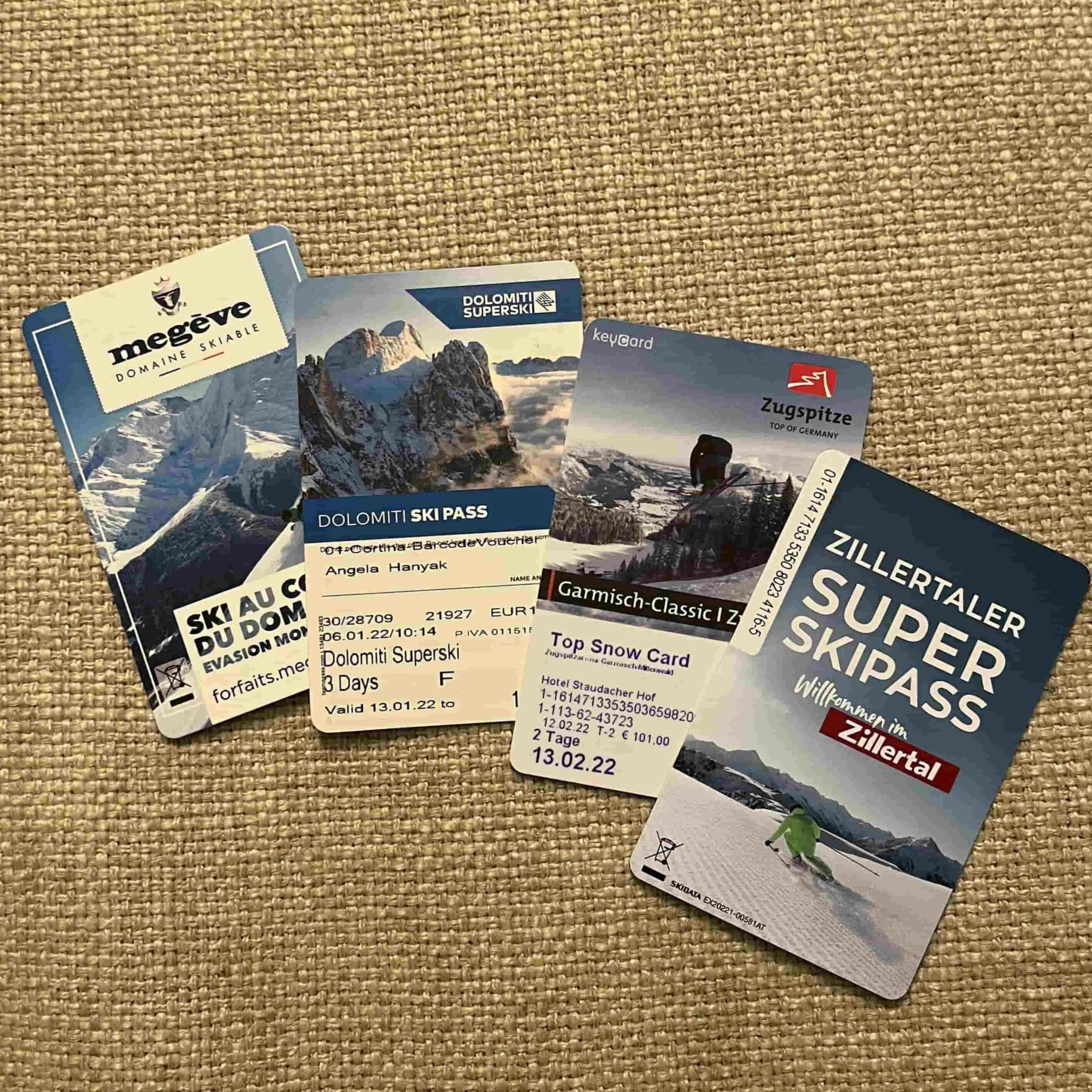 A stack of ski passes from various resorts in Europe.