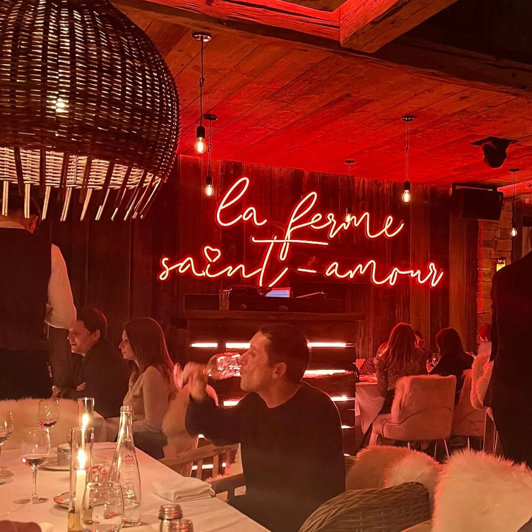 A neon sign reading La Ferme Saint-Amour at the restaurant of the same name in Megève, France.