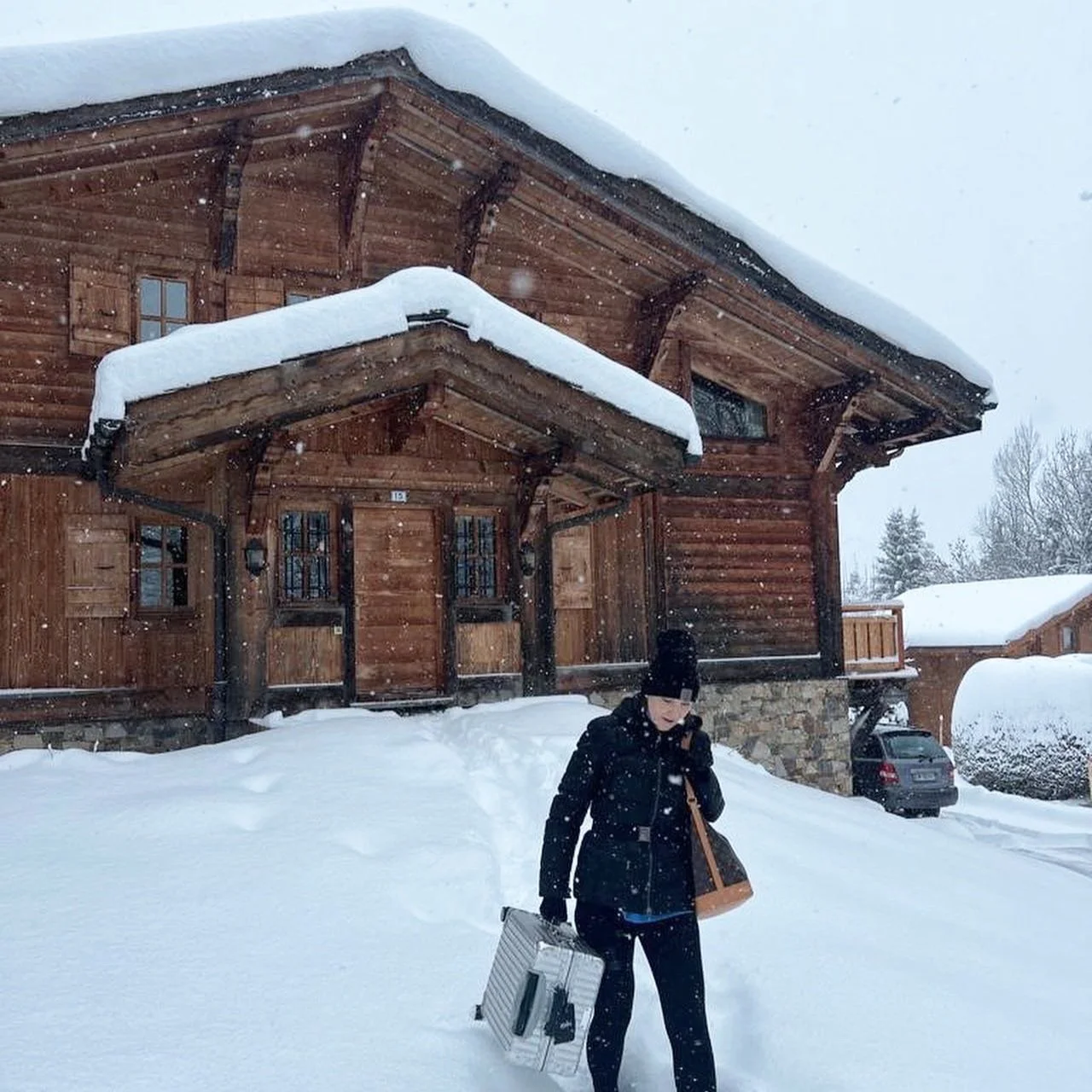 The author walking out of a snow-covered ski chalet in Megève, France.