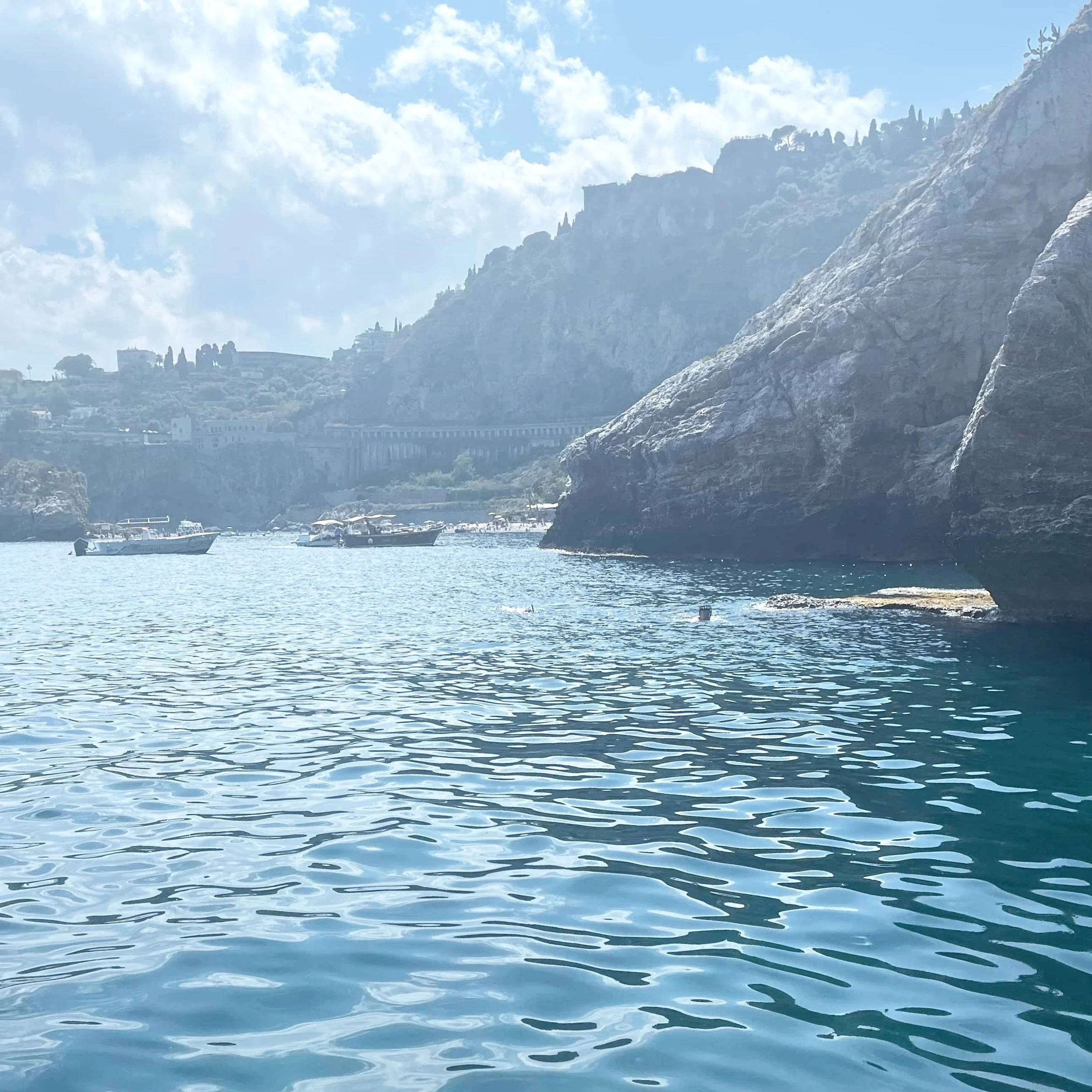 The rugged coastline of Taormina as seen from a boat.