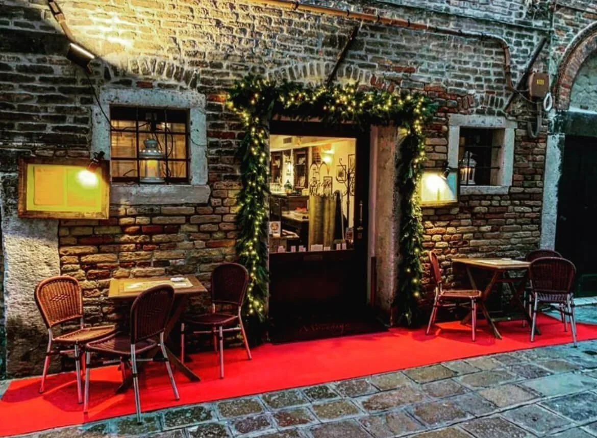 The stone facade of Osteria Mocenigo restaurant in Venice.