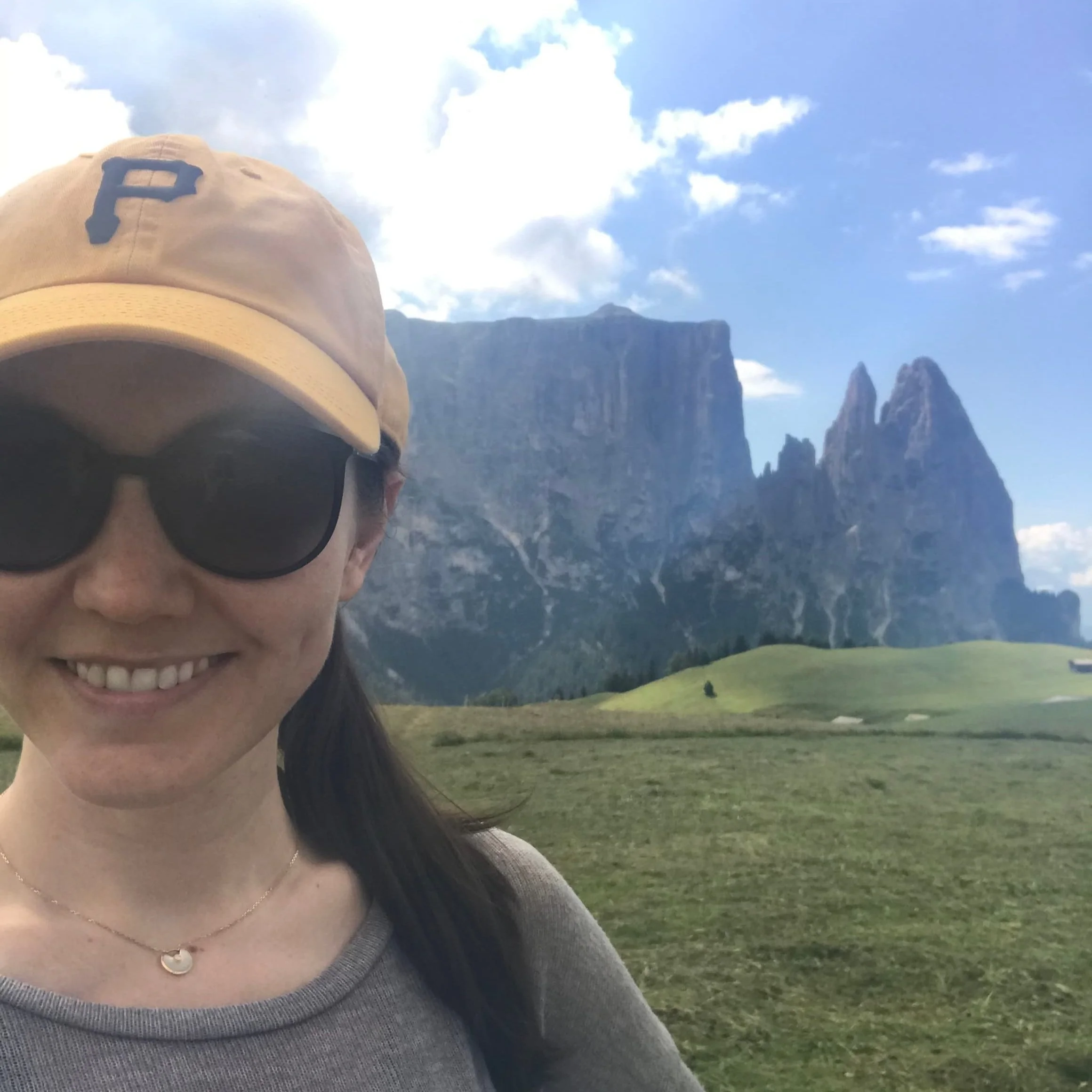 Solo female hiker in from of the Schlern mountain of the Dolomites.