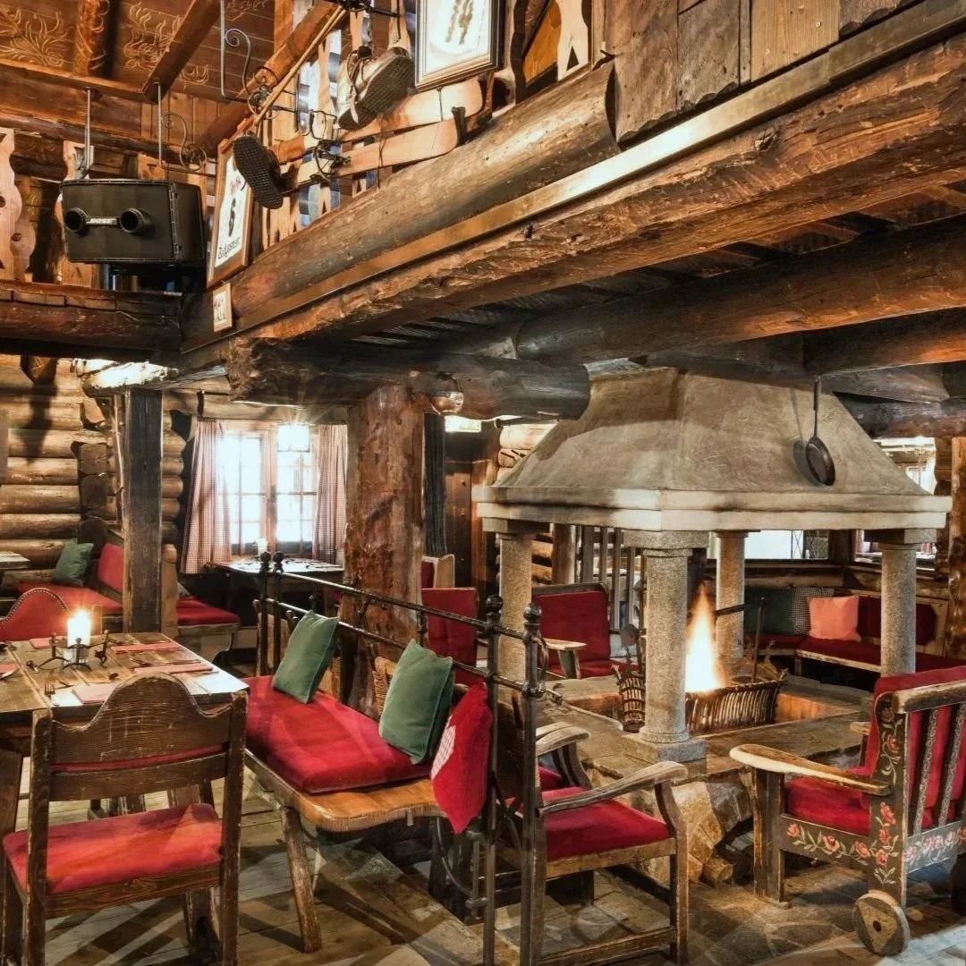 The Bellevue Alm Gastein restaurant is a mountain hut style restaurant with a grand hearth fire at its center.
