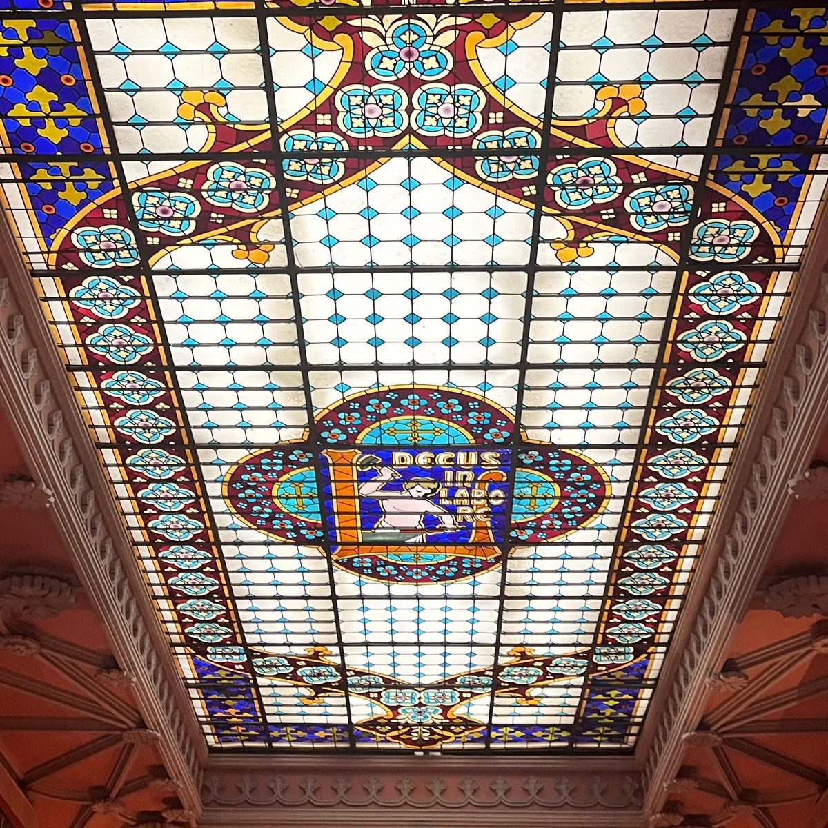 The stained-glass skylight at Livraria Lello in Porto, Portugal.