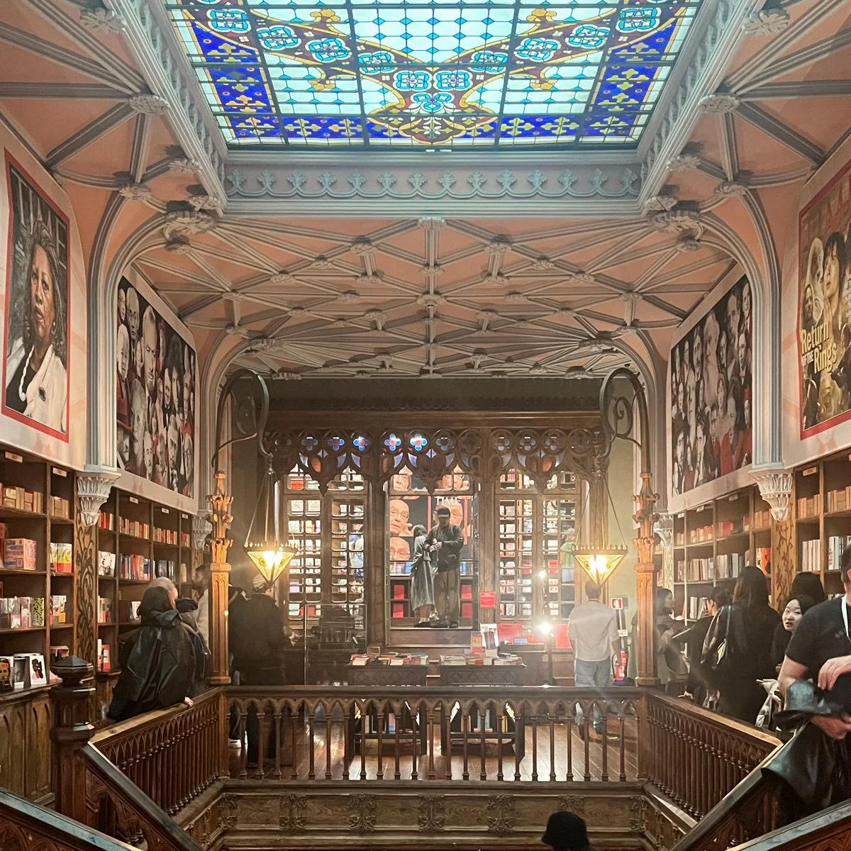 The interior of Livraria Lello features carved wood details and ornate ceiling decor.