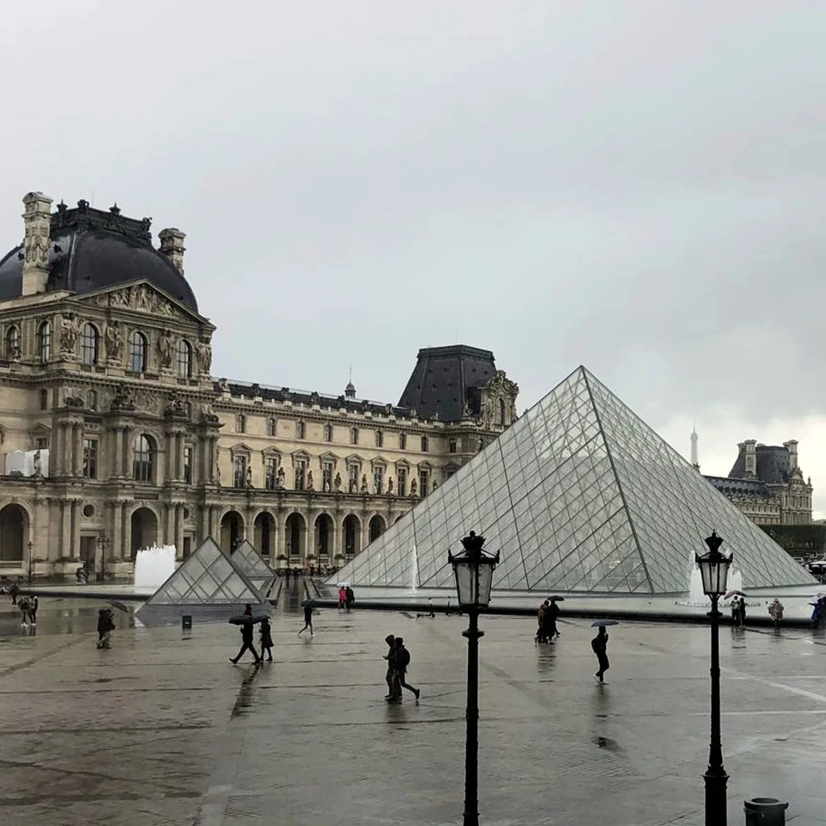 The exterior of the Louvre in Paris on an overcast day.