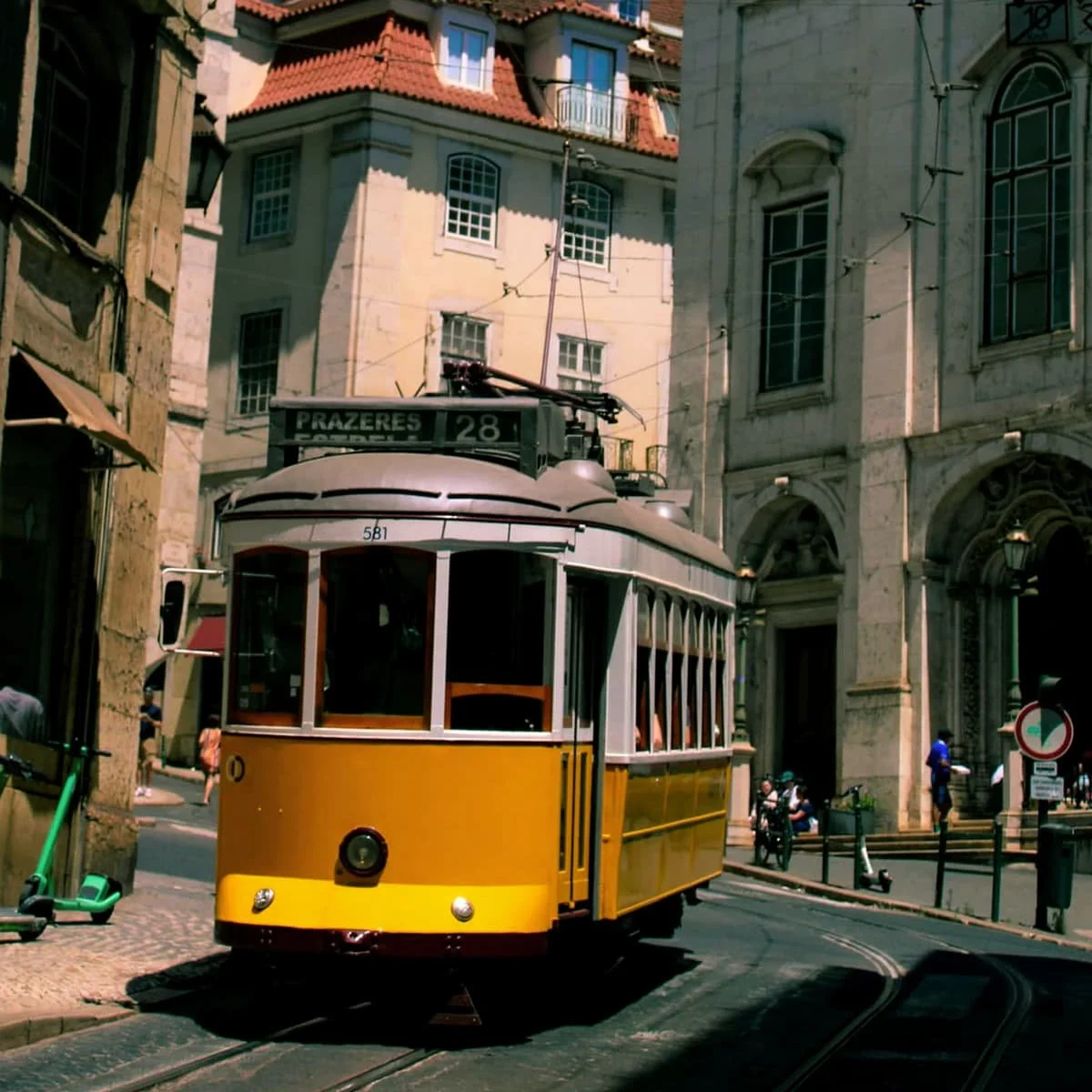 Tram 28 cutting through the streets of Lisbon, Portugal.